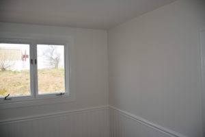 (After) New smooth ceiling, wallpaper removed and old wainscotting painted.